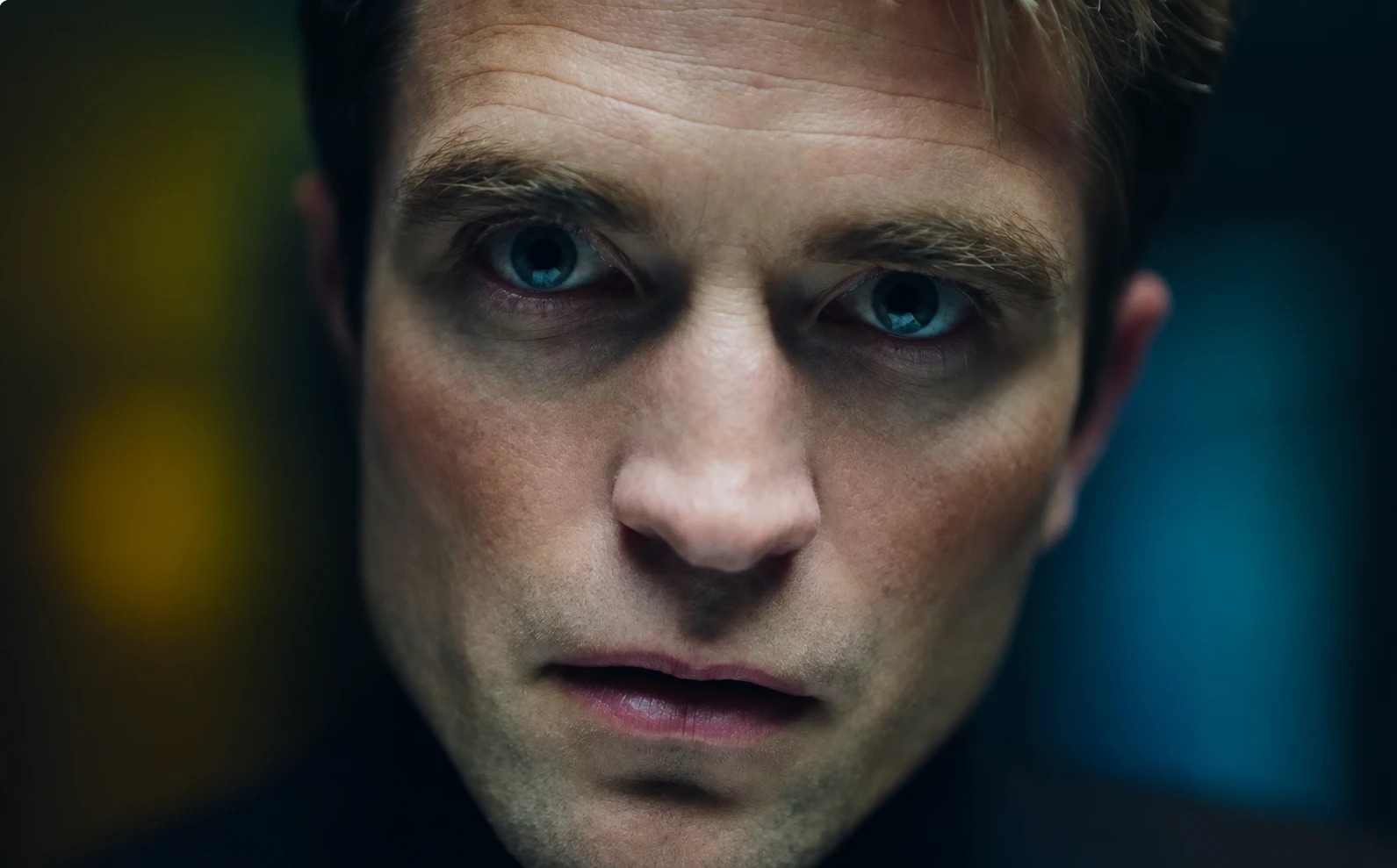 Still from Primetime: an extreme close-up of a man staring into the camera